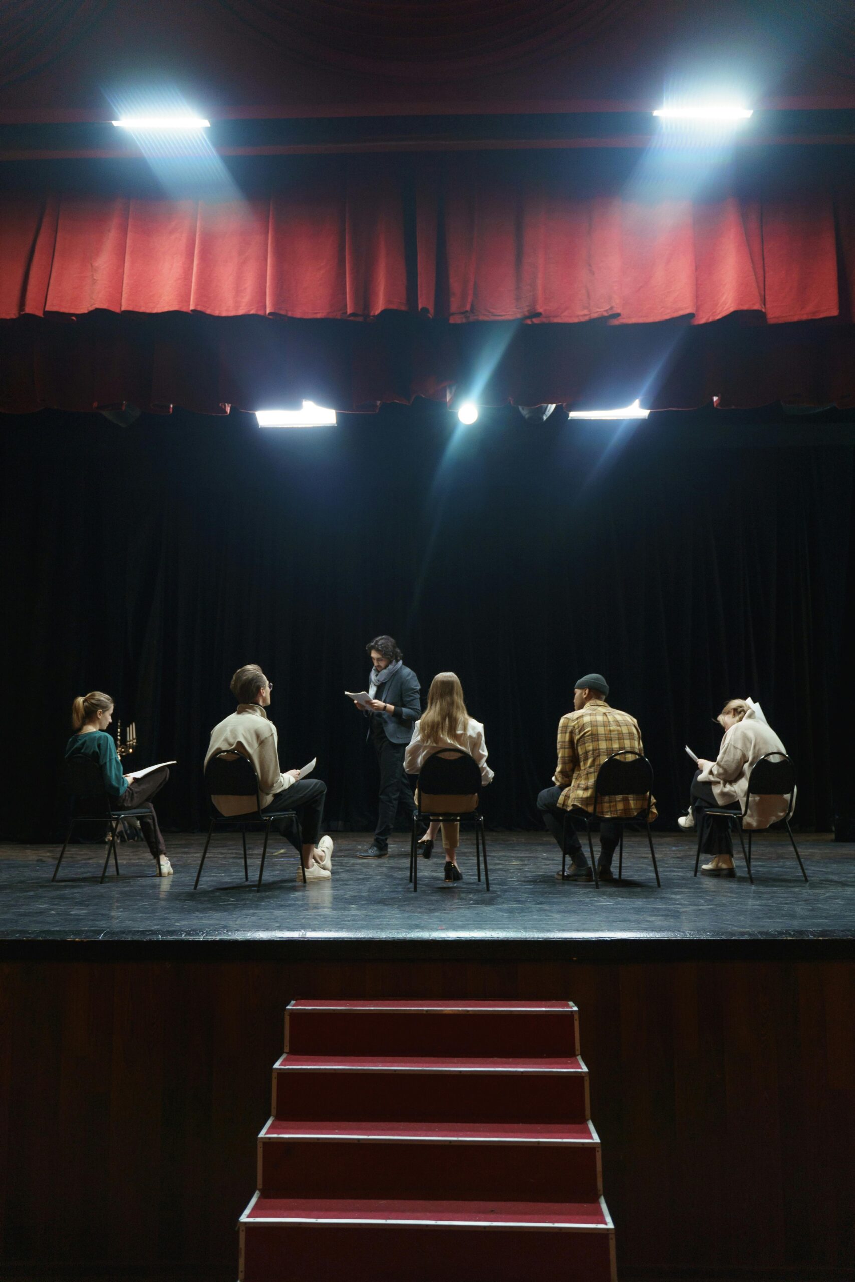 Group of People Sitting on Chair on Stage